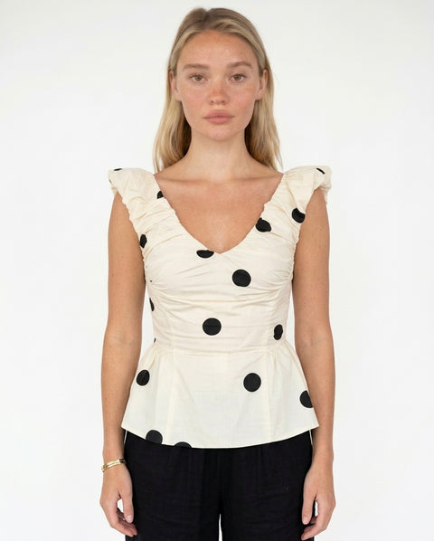 Top color crema a pois con arricciature e peplum